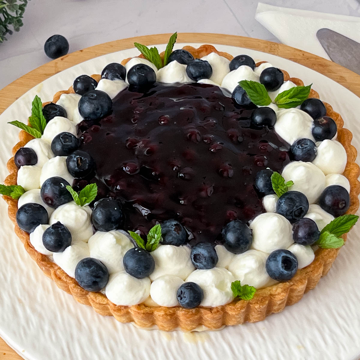 Fresh blueberry tart on the cake stand.