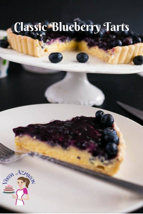 A blueberry tart on a cake stand.