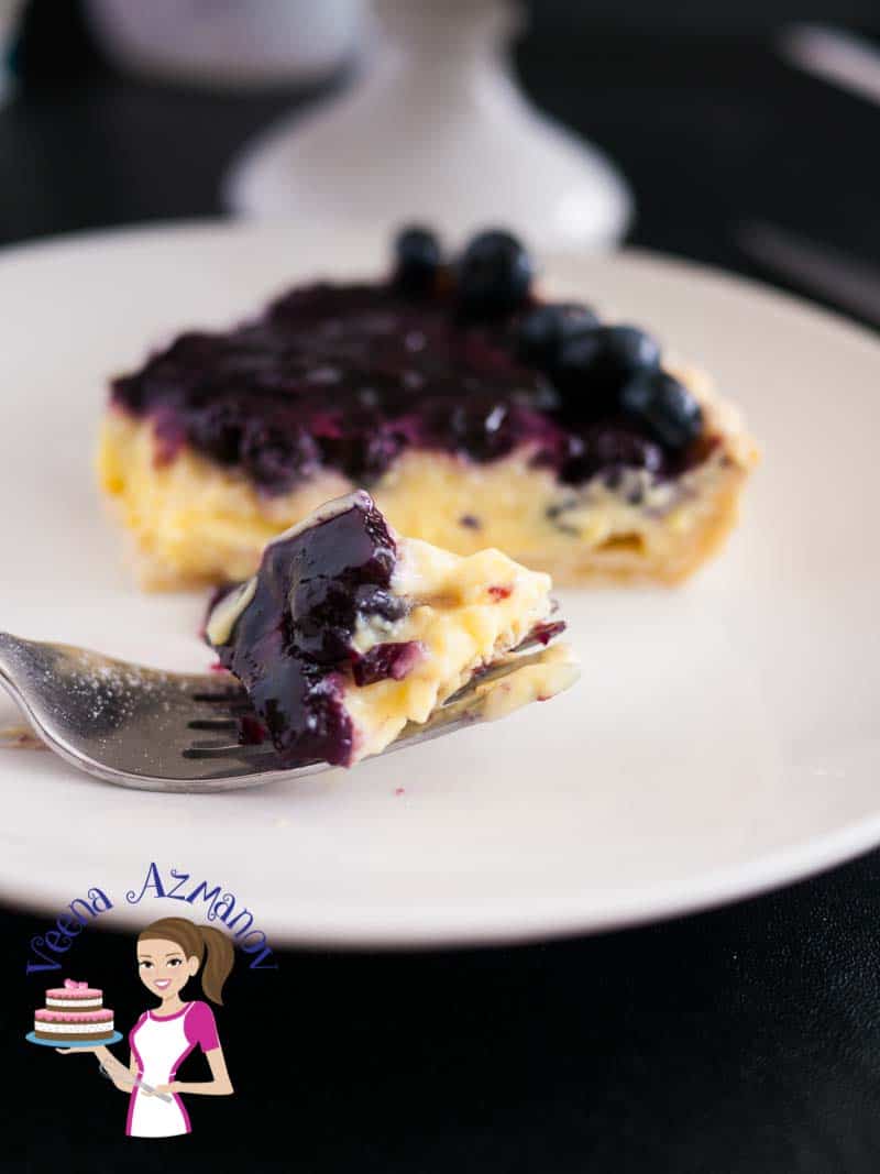 A slice of blueberry tart on a plate.