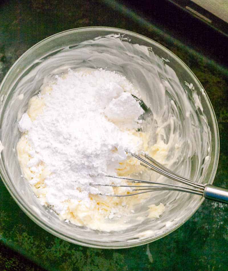 A mixing bowl with ingredients for cookie batter.