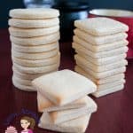 A stack of sugar cookies on a table.