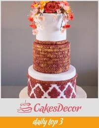A cake decorated in a burgundy damask design.