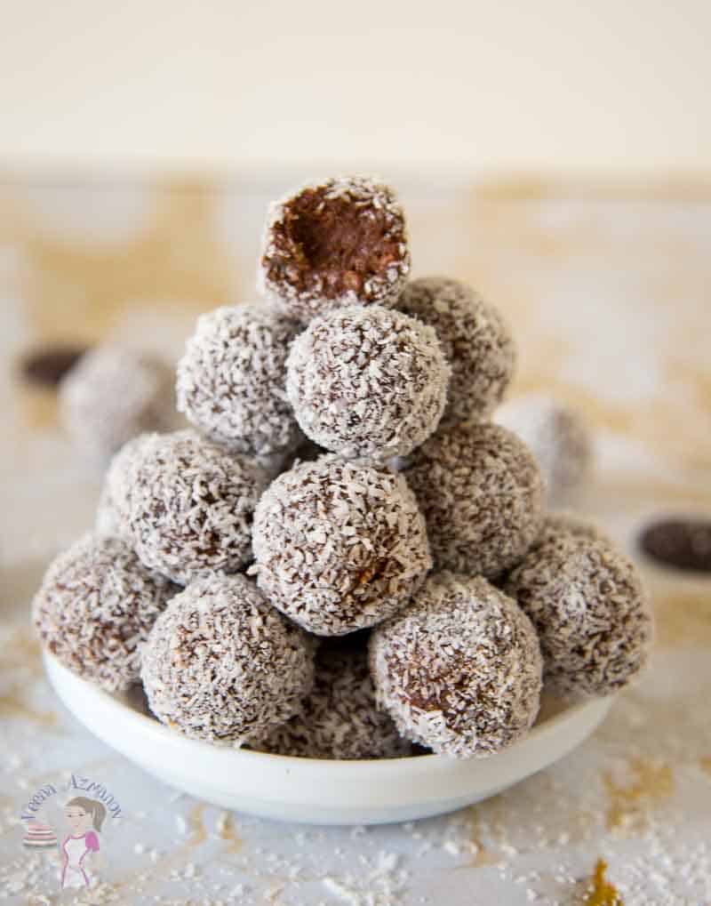A stack of coconut chocolate balls in a small plate.