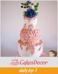 A wedding cake decorated with sugar flowers.