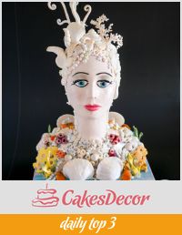 A cake sculpted to look like a lady of the sea.