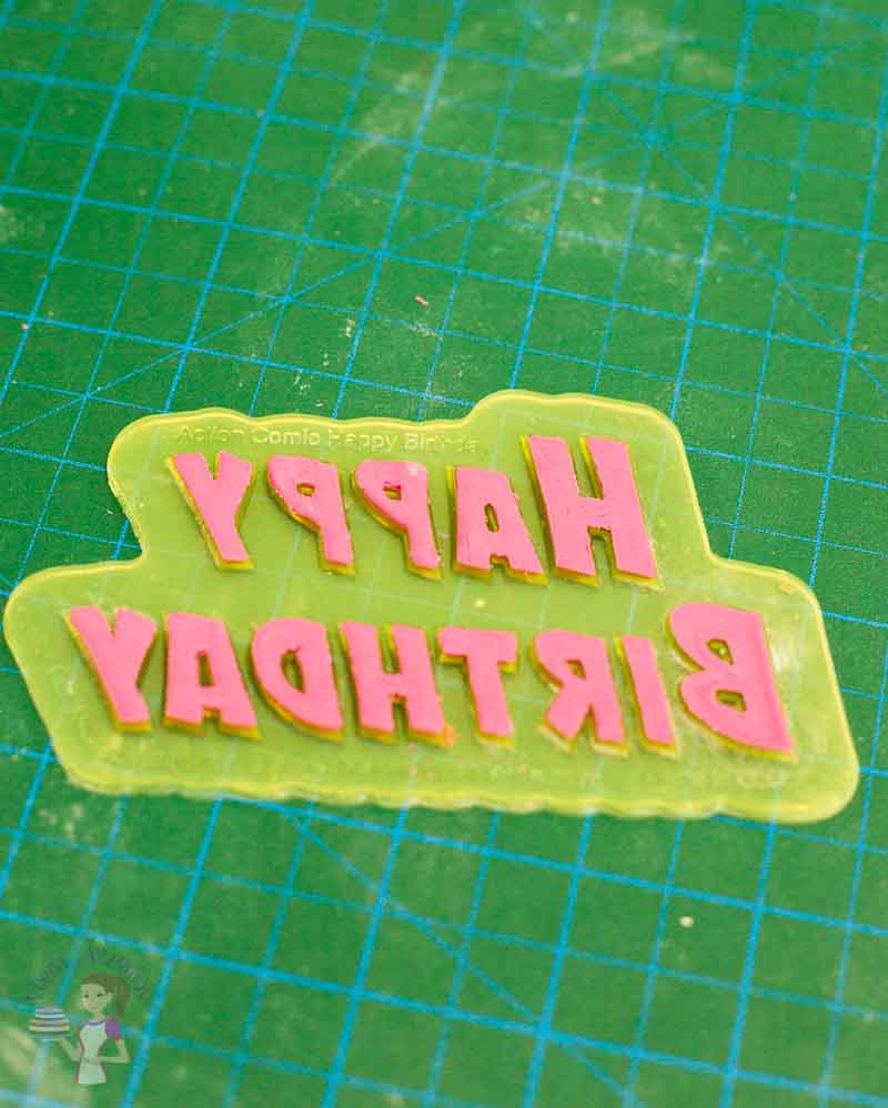 Making letters out of gum paste.