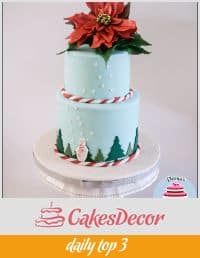 A cake decorated in a Christmas theme.