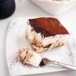 A piece of tiramisu on a plate.