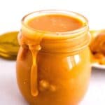 A mason jar with golden caramel filling.