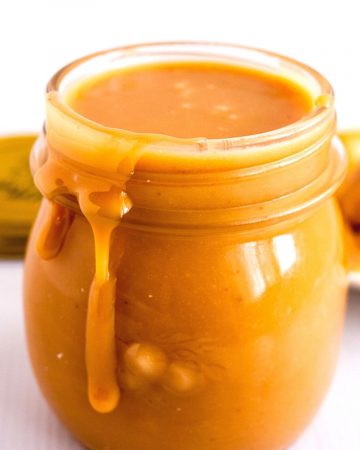 A mason jar with golden caramel filling.