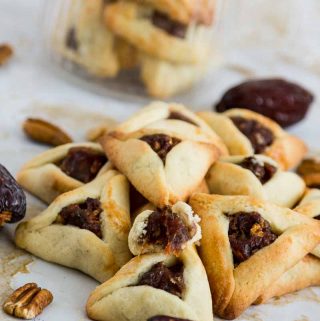Hamentaschen cookies are the highlight of Purim but traditional purim cookies are not eggless or dairy free which can be a disappointment for those with allergies. This simple, easy and effortless recipe for dairy free and eggless hamentaschen cookies can be made with any filling but today we have strawberry filled purim cookies.