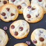 Eggless cookies with chocolate chips on a black board.