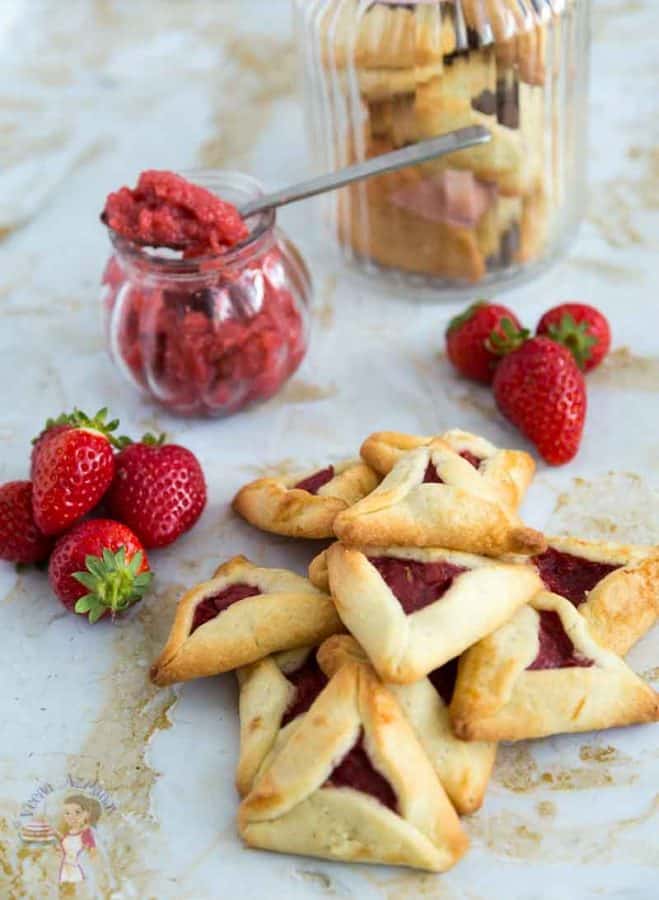 A stack of Purim cookies with strawberry filling.