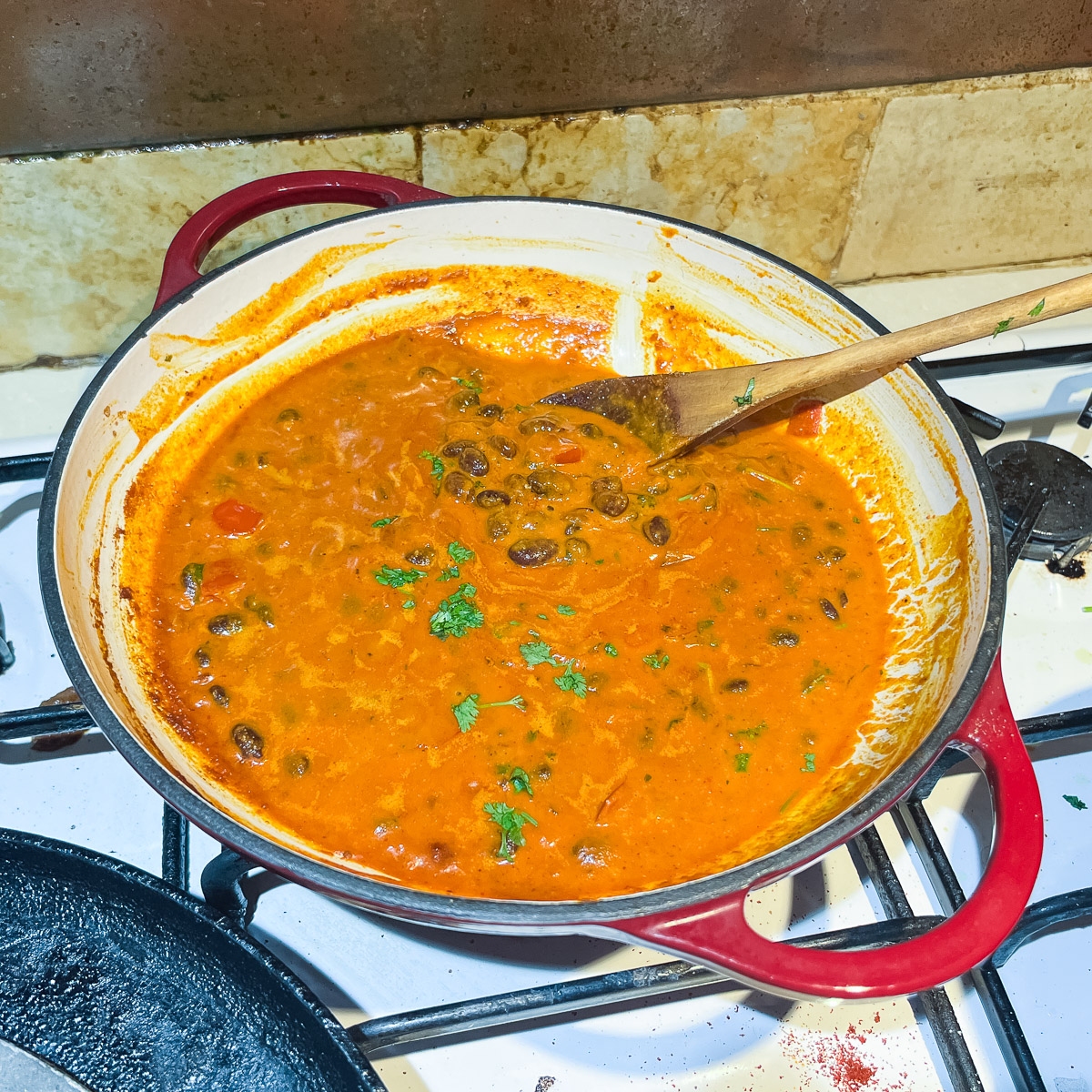 A skillet with kidney bean curry in coconut milk.