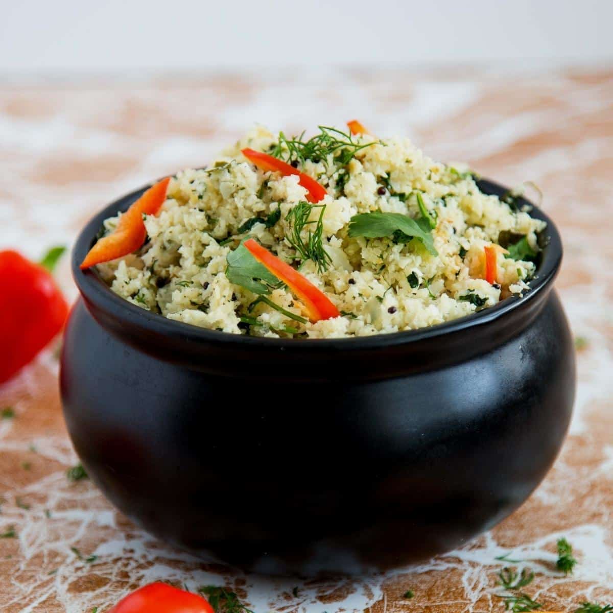 A bowl of cauliflower rice with mustard and dill