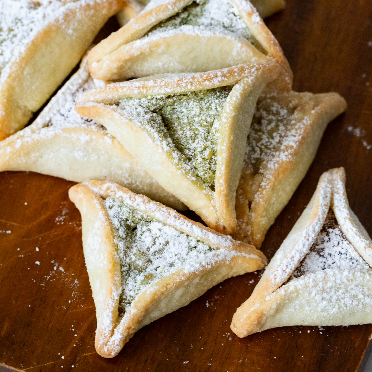 Pistachio hamantaschen purim cookies on the table.