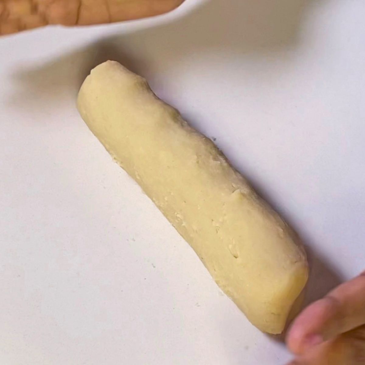 Rolling the sugar cookie dough into a log.