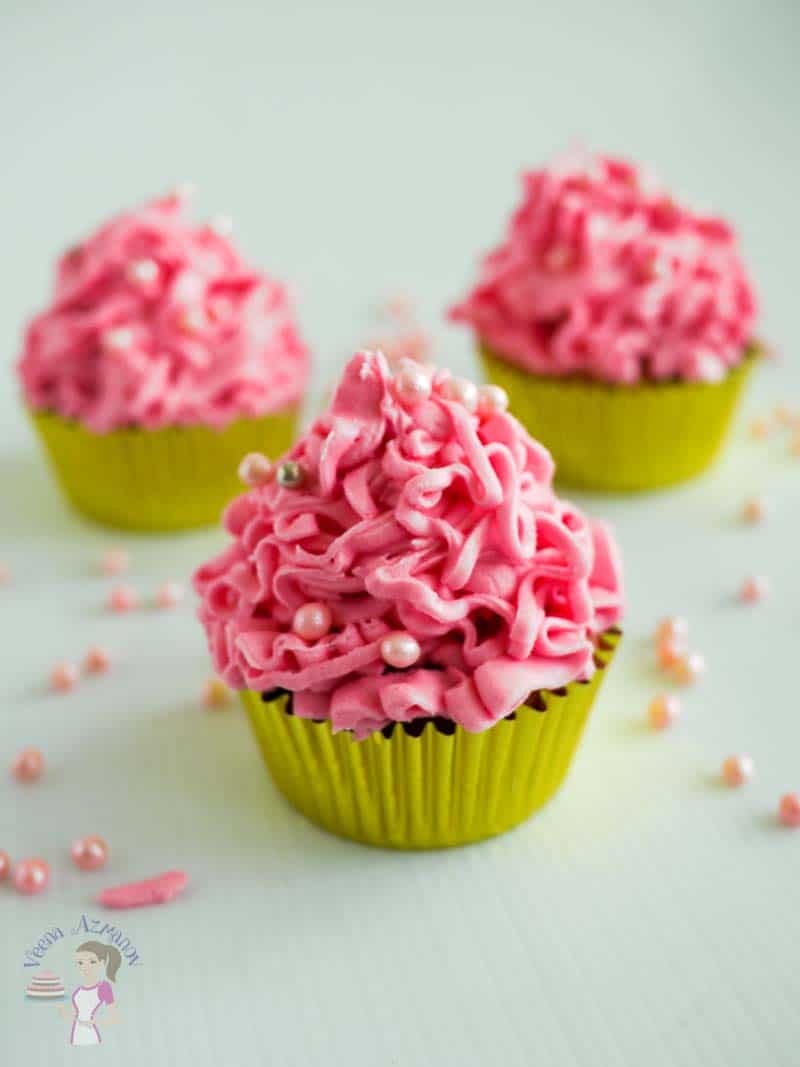 A cupcake with pink frosting.