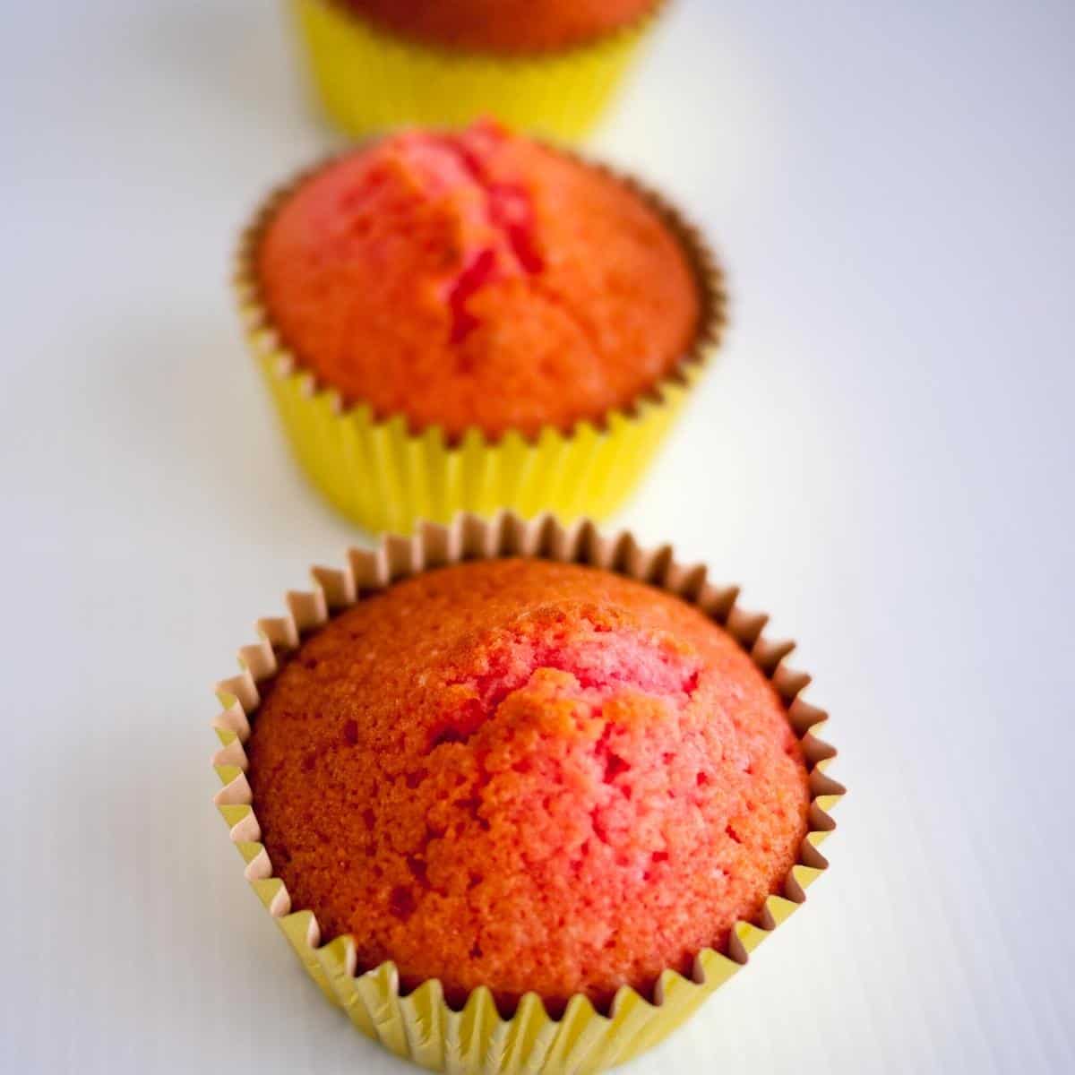 Fresh baked cupcakes in cupcake liners.
