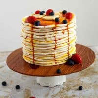 A decorated cake designed like a stack of pancakes.