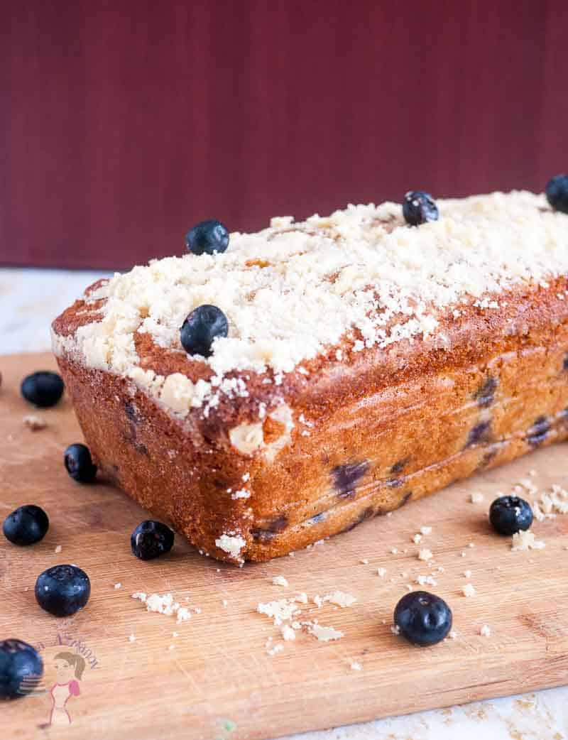 A blueberry cake on a wooden board.