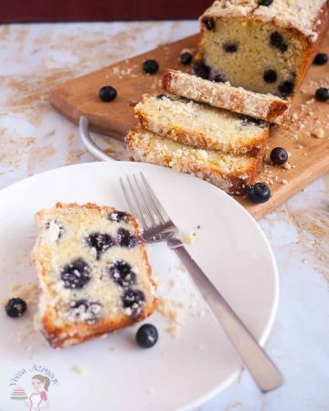 A slice of blueberry cake on a plate.