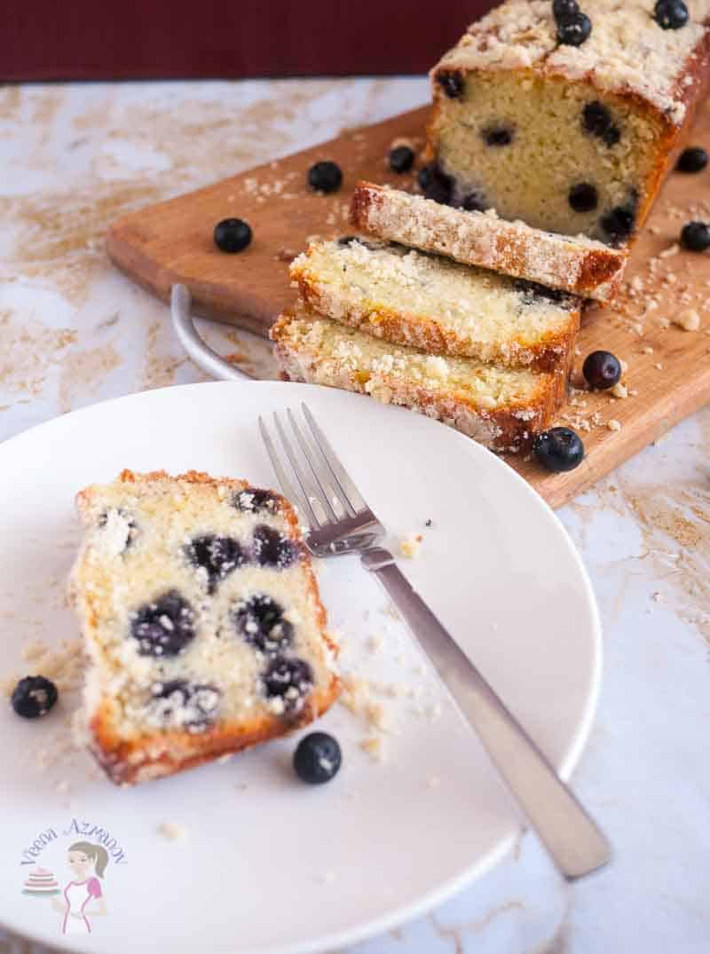 A slice of blueberry cake on a plate.