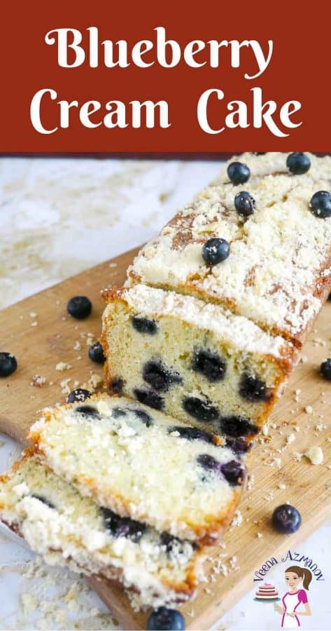 A sliced blueberry cake on a wooden board.