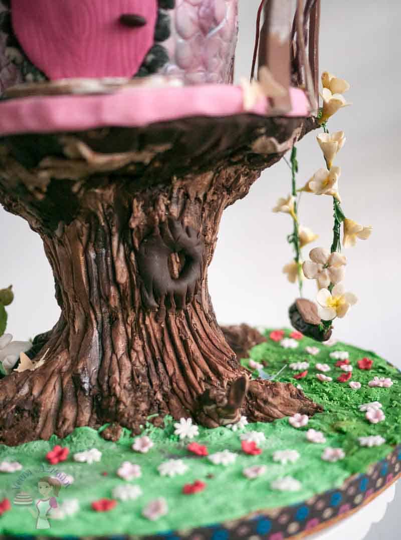 A close up of the trunk of a tree house cake.