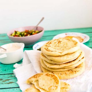 When you think Middle Eastern or Mediterranean food the humble pita always comes to mind. This simple, easy and effortless recipe for easy pita bread also known as pocket bread makes soft, chewy and delicious pita with a gorgeous pocket that can be stuffed with your favorites be it hummus, falafel, gyros, kebabs or even just cold cuts for a simple sandwich.