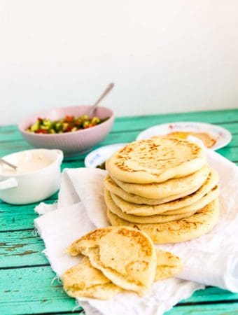 When you think Middle Eastern or Mediterranean food the humble pita always comes to mind. This simple, easy and effortless recipe for easy pita bread also known as pocket bread makes soft, chewy and delicious pita with a gorgeous pocket that can be stuffed with your favorites be it hummus, falafel, gyros, kebabs or even just cold cuts for a simple sandwich.