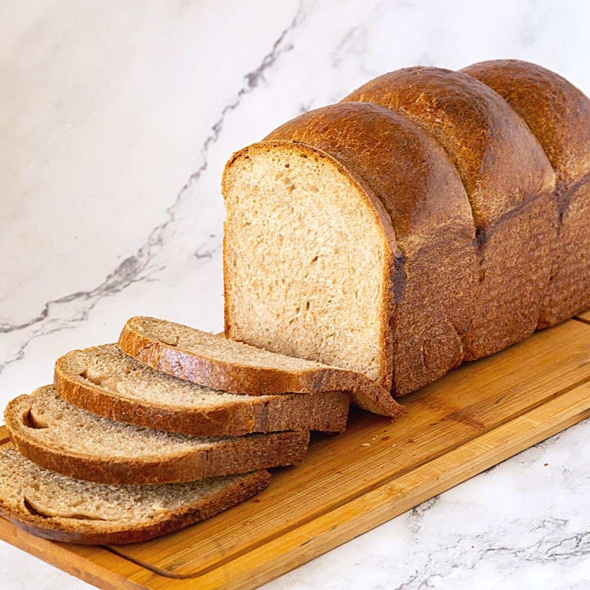 A sliced bread on a wooden board.