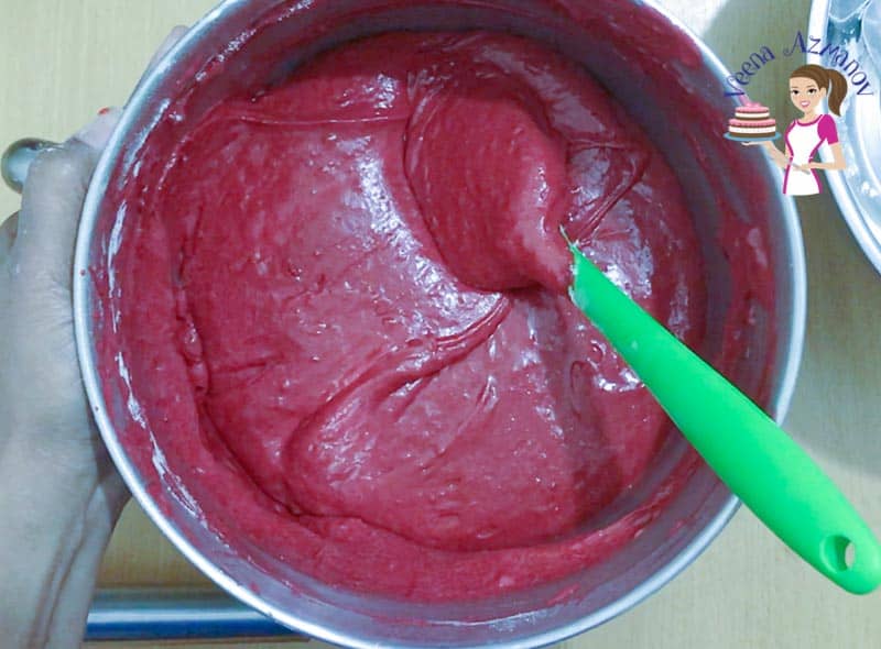 A bowl with batter for a red velvet cake.