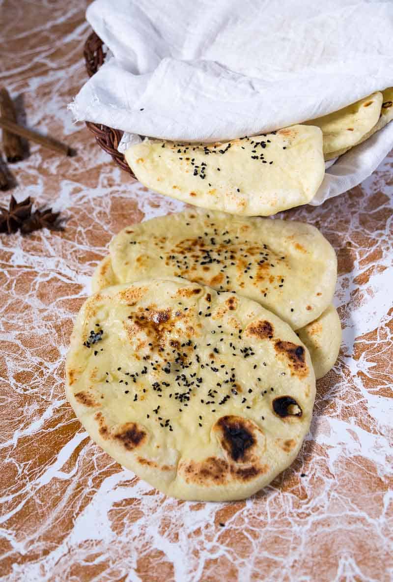 A garlic butter naan is a variation on the classic Indian naan recipe that is often accompanied with an Indian meal.  This simple, easy and effortless recipe makes a deliciously soft and chewy garlic butter naan that just melts in the mouth.