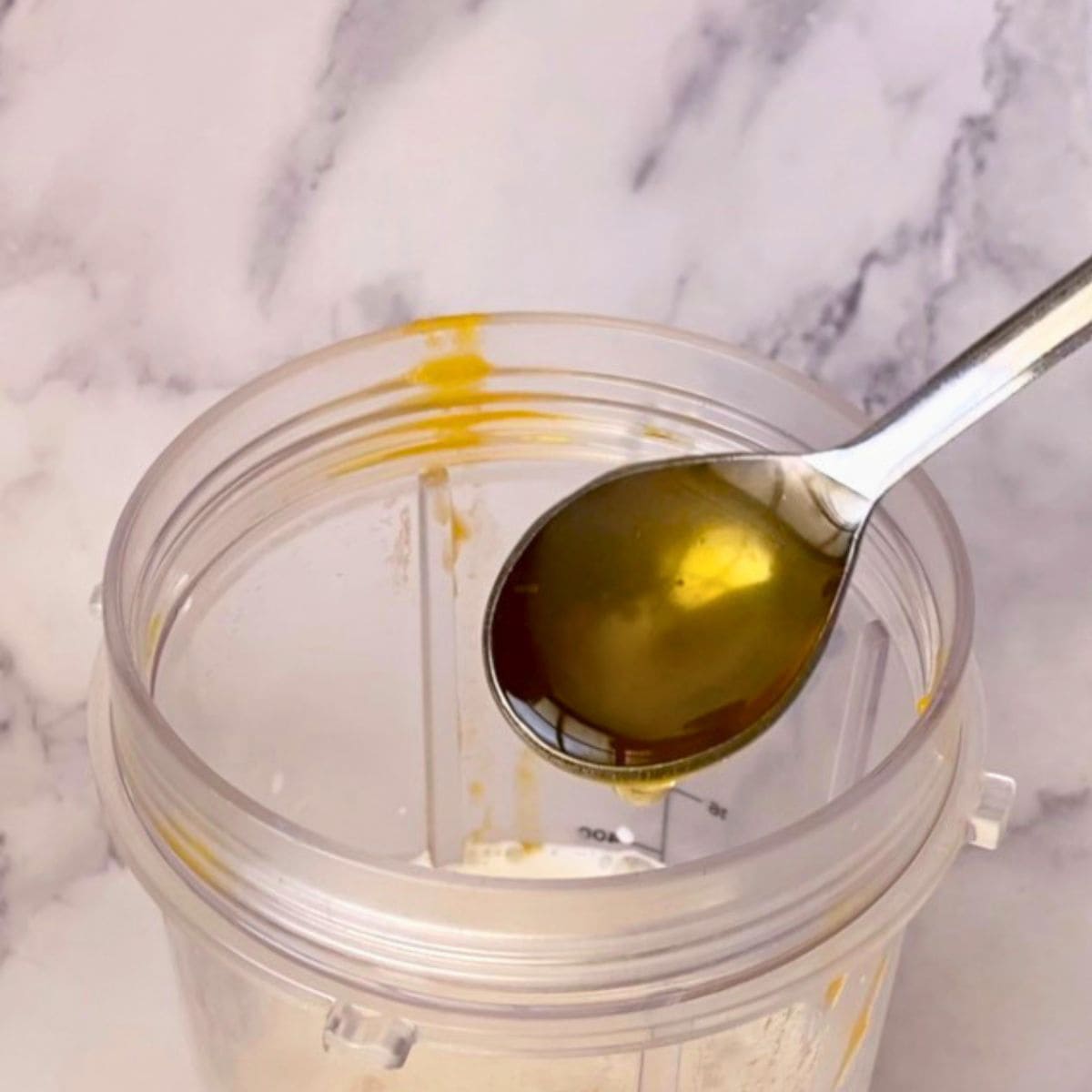 Adding honey to the blender.