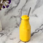 Mango coconut smoothie in a glass.