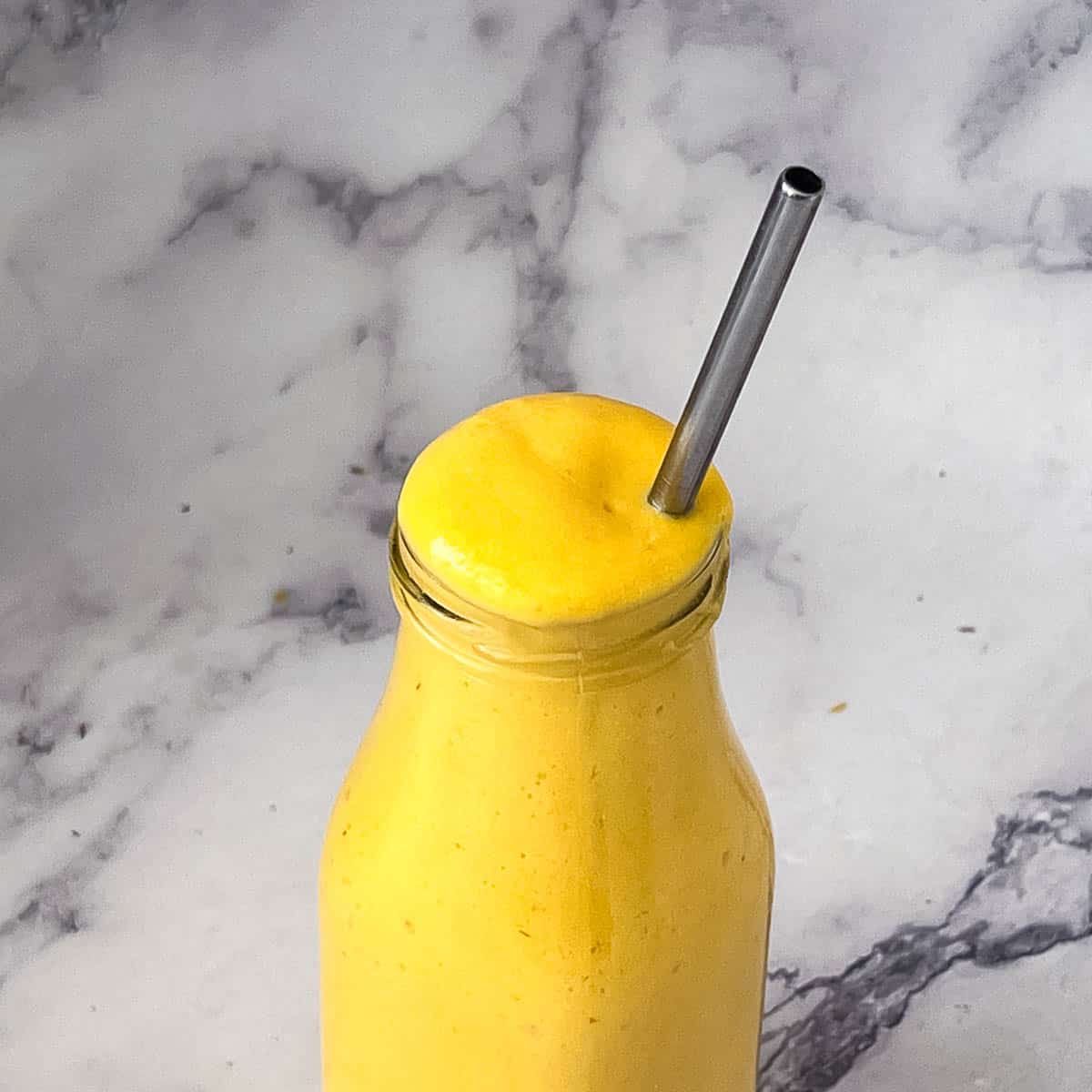 A bottle with coconut mango smoothie.