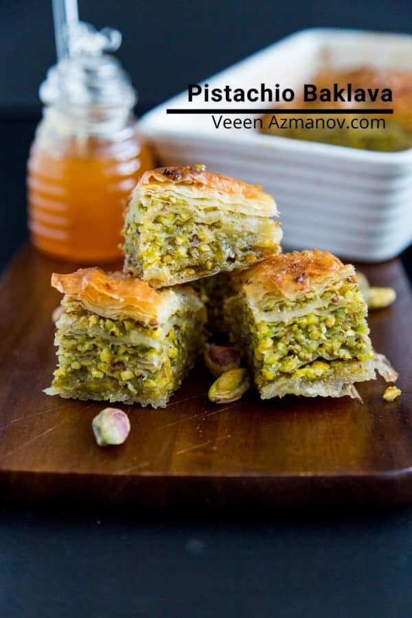 Three squares of pistachio baklava on a table.