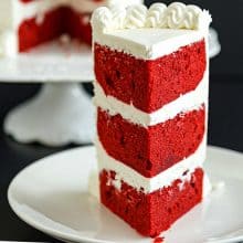 A slice of red velvet layer cake.