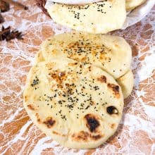 Stack of naan on the table.