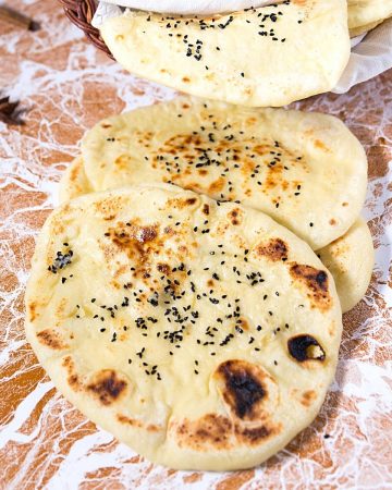 Stack of naan on the table.