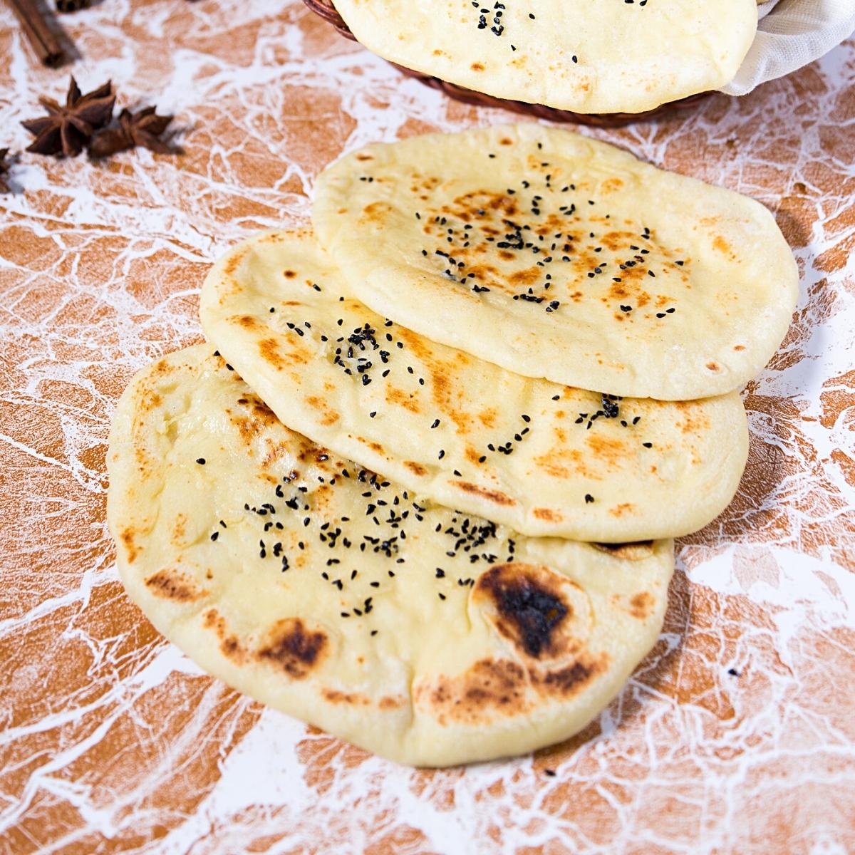 A stack of naan on the table.
