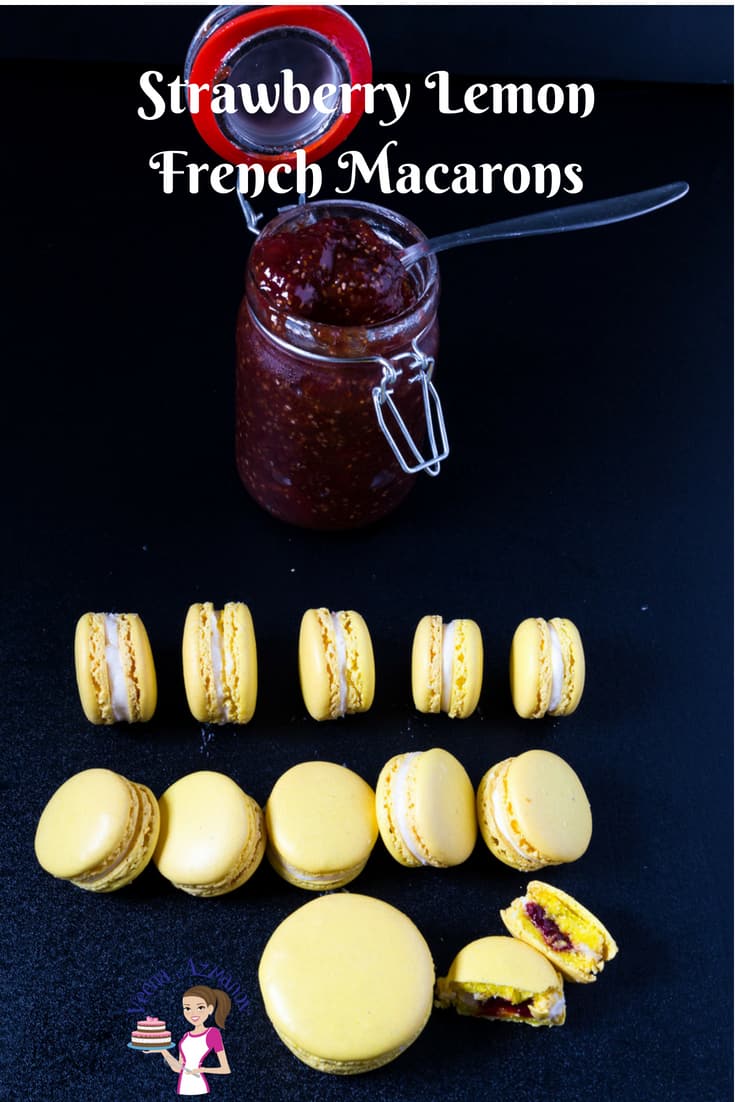 Strawberry Lemon French Macarons - Crisp lemon flavored macaron shells filled with tart-sweet homemade strawberry jam surrounded by velvety smooth Swiss meringue buttercream that just melts in the mouth. My simple, easy and effortless recipe for strawberry lemon French macarons is a no-fail recipe and will make sure you have perfect macarons every single time. #strawberry #macaron #French #lemon #jam #Swiss-meringue #no-fail-recipe, A Pinterest Optimized image for these strawberry lemon French macarons featuring strawberry jam and lemon macarons in place on a black background