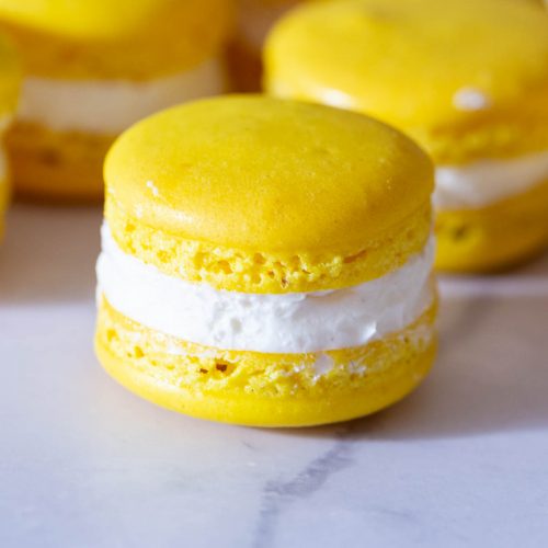 stack of yellow macarons on the table.