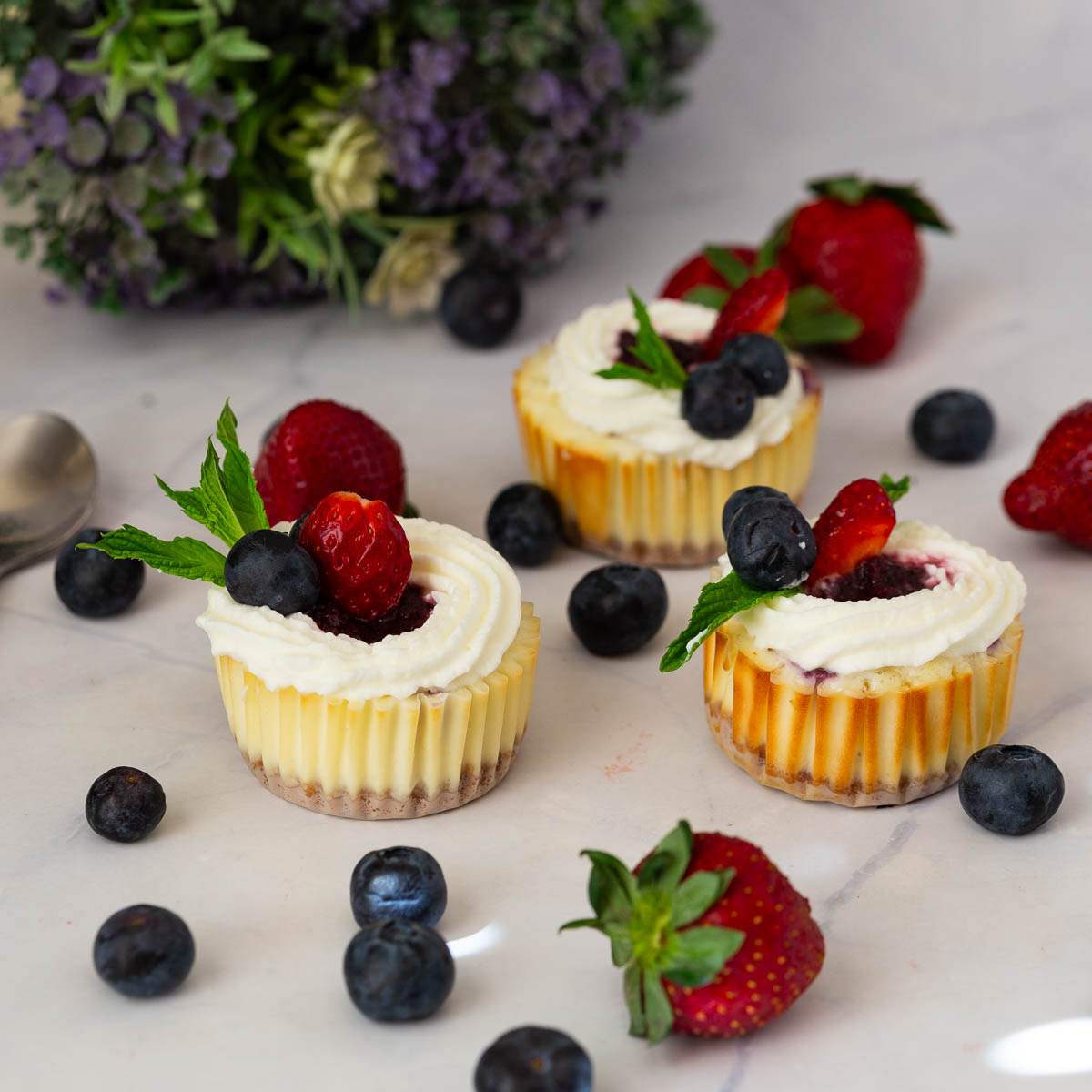 Mini Cheesecakes on the table with fruits.