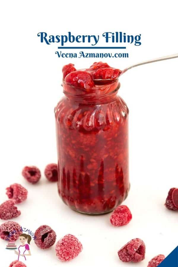 Jar and spoon with fruit filling - raspberries.