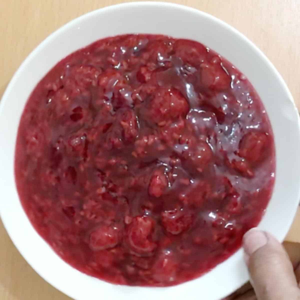 A bowl with raspberry fruit filling.
