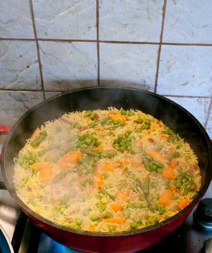 This one pot vegetable rice is kids absolute favorite dish because it's lightly flavored with just the right amount of vegetables. This simple, easy and effortless recipe can be served as a main course on its own for a light meal or as an accompaniment to the main course. The best part is, it takes only 15 minutes to cook so quick one pot meal is a possibility.