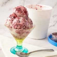 scoops of no churn blackberries ice cream in a bowl.