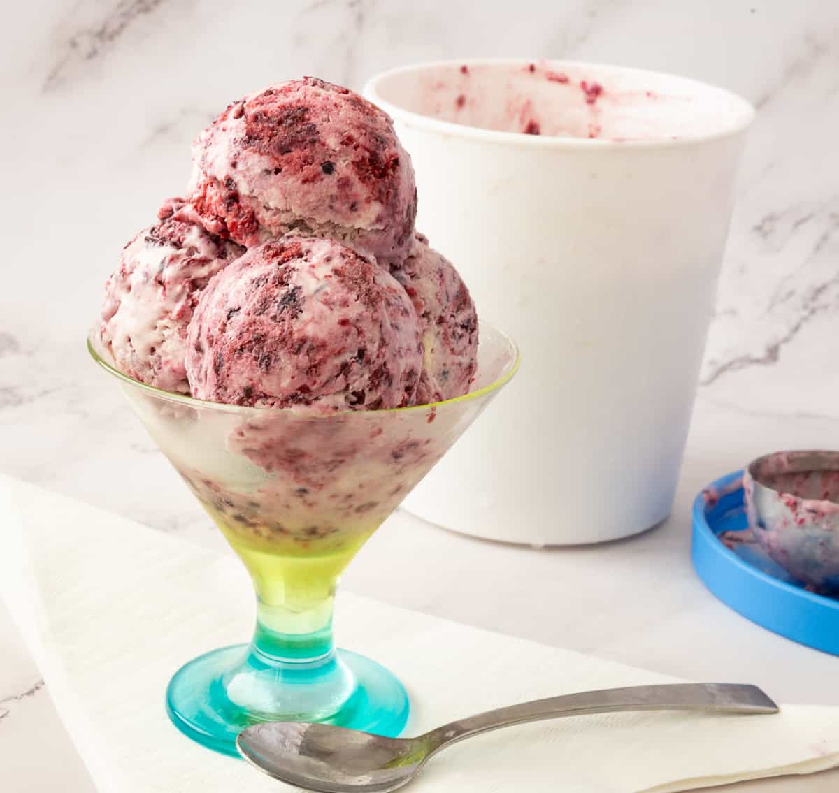 scoops of no churn blackberries ice cream in a bowl.